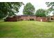 Large backyard showcasing a brick home with a well-maintained lawn, ideal for outdoor entertaining at 2836 20Th Street Ne Ln, Hickory, NC 28601