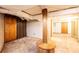 Unfinished basement with support pole, wood paneling, concrete floor, and utility pipes on the ceiling at 2836 20Th Street Ne Ln, Hickory, NC 28601