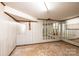 Unfinished basement showing painted wood paneling, concrete flooring, and mirrored wall at 2836 20Th Street Ne Ln, Hickory, NC 28601