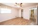 Bedroom featuring plank floors, window, and ceiling fan; view into the hallway at 2836 20Th Street Ne Ln, Hickory, NC 28601