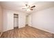 Bright bedroom with plank floors, ceiling fan, and ample closet space for storage at 2836 20Th Street Ne Ln, Hickory, NC 28601