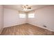 Bedroom showcases plank flooring, large windows, and neutral walls; ceiling fan not visible at 2836 20Th Street Ne Ln, Hickory, NC 28601