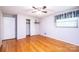 View of the bedroom reveals hardwood floors, closet, window, and ceiling fan at 2836 20Th Street Ne Ln, Hickory, NC 28601