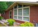 Close-up of the home's brick facade, large windows, and neatly landscaped flower beds at 2836 20Th Street Ne Ln, Hickory, NC 28601