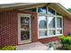 A welcoming front entrance with a stylish glass door, brick accents, and manicured greenery at 2836 20Th Street Ne Ln, Hickory, NC 28601