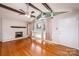 Bright living room with hardwood floors, white brick fireplace, and large windows at 2836 20Th Street Ne Ln, Hickory, NC 28601
