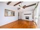 Bright living room featuring hardwood floors, a white brick fireplace, and a stylish ceiling fan at 2836 20Th Street Ne Ln, Hickory, NC 28601