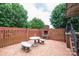 A brick patio with a stone table and benches, surrounded by brick walls, offering an inviting outdoor space at 2836 20Th Street Ne Ln, Hickory, NC 28601