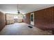Covered patio area with brick walls and a ceiling fan, ideal for outdoor relaxation and comfort at 2836 20Th Street Ne Ln, Hickory, NC 28601