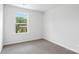 Simple bedroom featuring neutral carpet, white walls, and a large window with greenery views at 3140 Ora Smith Rd, Lincolnton, NC 28092
