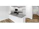 Well-lit kitchen with granite counters, stainless steel appliances, and wood floors at 3140 Ora Smith Rd, Lincolnton, NC 28092