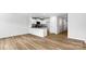 Open concept living space with wood floors and bright, white kitchen with granite countertops at 3140 Ora Smith Rd, Lincolnton, NC 28092