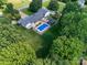 Aerial view showcasing the property and its landscaping, featuring a pool and a home at 3509 Flint Dr, Statesville, NC 28677