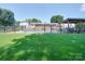 Expansive backyard featuring an in-ground pool, gazebo, and lush lawn, enclosed by a black metal fence at 3509 Flint Dr, Statesville, NC 28677
