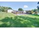 Spacious backyard with well maintained lawn, inground pool, and gazebo, all secured with a black metal fence at 3509 Flint Dr, Statesville, NC 28677
