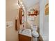 Cozy bathroom with a neutral color scheme, featuring a wooden vanity, toilet, and decorative accents at 3509 Flint Dr, Statesville, NC 28677