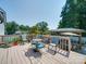 Spacious outdoor deck with dining area and railing overlooking the backyard at 3509 Flint Dr, Statesville, NC 28677