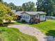 Charming home featuring a front porch, gravel driveway, and well-maintained lawn at 3509 Flint Dr, Statesville, NC 28677
