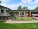 Charming front exterior featuring stone accents, well-maintained landscaping, and covered parking at 3509 Flint Dr, Statesville, NC 28677