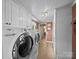 Functional laundry room with tile floors, storage cabinets, and modern front-loading washer and dryer at 3509 Flint Dr, Statesville, NC 28677
