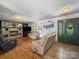 Cozy living room featuring a stone fireplace, hardwood floors, and comfortable seating at 3509 Flint Dr, Statesville, NC 28677
