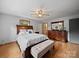 Comfortable bedroom with wood floors, ceiling fan, and ample closet space at 3509 Flint Dr, Statesville, NC 28677