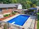 Aerial view of backyard and brick house featuring an in-ground pool and patio at 3509 Flint Dr, Statesville, NC 28677