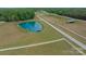 Picturesque property with a serene pond featuring a dock, surrounded by vast green pastures at 355 Pelham Ln, Mooresville, NC 28115