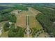 Overhead view of an extensive estate with lush landscaping, pastures, and serene pond at 355 Pelham Ln, Mooresville, NC 28115