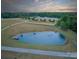 The sprawling acreage features a stocked pond and a barn in the background at 355 Pelham Ln, Mooresville, NC 28115