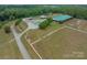 Expansive equestrian estate featuring horse facilities, multiple barns, and fenced pastures at 355 Pelham Ln, Mooresville, NC 28115