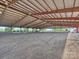 The large riding arena is dirt with a full covering and bright lighting at 355 Pelham Ln, Mooresville, NC 28115