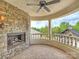 Beautiful balcony with stone fireplace, elegant columns, and stunning natural views at 355 Pelham Ln, Mooresville, NC 28115