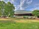Exterior of a large metal barn with open sides surrounded by well-maintained greenery at 355 Pelham Ln, Mooresville, NC 28115