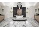 This bathroom features marble floors, black accents, a soaker tub, and a modern chandelier at 355 Pelham Ln, Mooresville, NC 28115