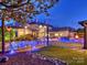 Beautifully lit exterior with pool, water features, landscaped yard, and an inviting seating area at 355 Pelham Ln, Mooresville, NC 28115