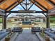 View of the home's impressive exterior, complemented by a pool, landscaping, and outdoor living space at 355 Pelham Ln, Mooresville, NC 28115