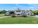 Elegant home featuring manicured lawn and landscaping, circular driveway, and a grand entrance at 355 Pelham Ln, Mooresville, NC 28115