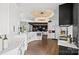 Open-concept kitchen featuring white cabinetry, modern appliances, and hardwood flooring at 355 Pelham Ln, Mooresville, NC 28115
