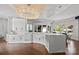 Open-concept kitchen with white cabinets, island, and hardwood floors at 355 Pelham Ln, Mooresville, NC 28115