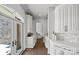 Hallway featuring white cabinetry and stone wall and glass door leading to the exterior of the home at 355 Pelham Ln, Mooresville, NC 28115