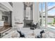 Living room featuring high ceilings, fireplace, and a decorative chandelier at 355 Pelham Ln, Mooresville, NC 28115
