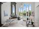 Bright living room featuring high ceilings, expansive windows and a decorative chandelier at 355 Pelham Ln, Mooresville, NC 28115