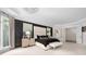 This primary bedroom has a tray ceiling, large windows, and a tufted headboard feature wall at 355 Pelham Ln, Mooresville, NC 28115
