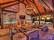 Luxurious outdoor living area with a fireplace, comfortable seating, a kitchen, and elegant lighting at 355 Pelham Ln, Mooresville, NC 28115