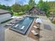 Aerial view of a stunning backyard featuring a modern pool, lounge chairs, and an outdoor living space at 355 Pelham Ln, Mooresville, NC 28115
