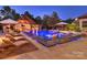 Inviting pool featuring integrated lounge chairs, ambient lighting, and an adjacent outdoor entertainment area at 355 Pelham Ln, Mooresville, NC 28115