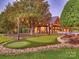 Backyard with a putting green, outdoor kitchen, pool, mature trees, and decorative lighting at 355 Pelham Ln, Mooresville, NC 28115