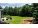 Expansive backyard featuring a manicured lawn, rock landscaping, and privacy trees at 3622 46Th Ne Ave, Hickory, NC 28601
