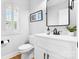 Powder room featuring modern fixtures, white vanity, and square mirror at 3622 46Th Ne Ave, Hickory, NC 28601